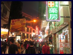 Old town pedestrian area at night. Many neon signs.